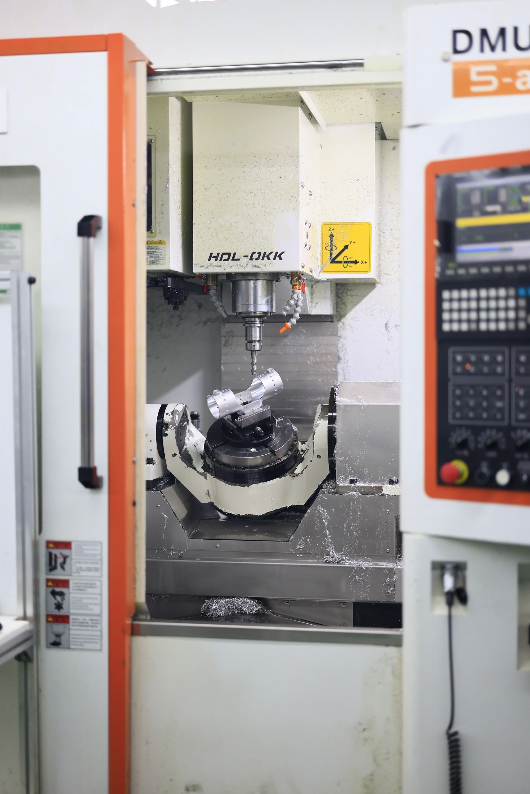 5-axis CNC machining of a precision robotics component on a trunnion rotary table